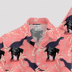 Pink dinosaur aloha shirt with dog faces and palm tree patterns