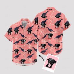 Pink dinosaur aloha shirt with dog faces and palm tree patterns