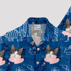 Blue Hawaiian shirt with dinosaur, cat face, and playful pattern
