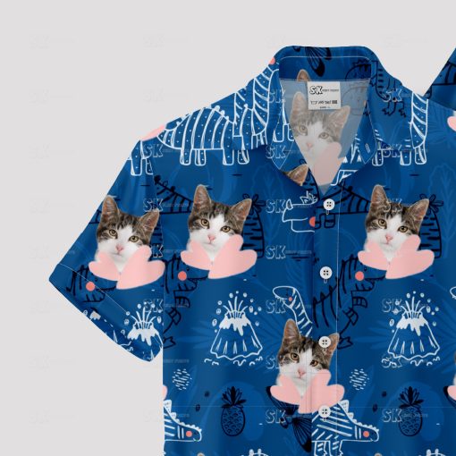 Blue Hawaiian shirt with dinosaur, cat face, and playful pattern