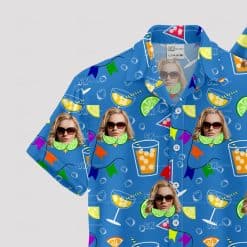 Blue Hawaiian shirt with cocktail glasses, faces, and party flags pattern
