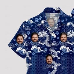 Blue aloha shirt with white dragons, clouds, waves, and face images