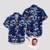 Blue aloha shirt with white dragons, clouds, waves, and face images