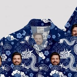 Blue aloha shirt with white dragons, clouds, waves, and face images