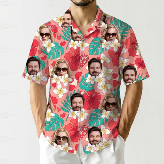 Couples matching tropical outfits with faces, tropical leaves, and red hibiscus flowers