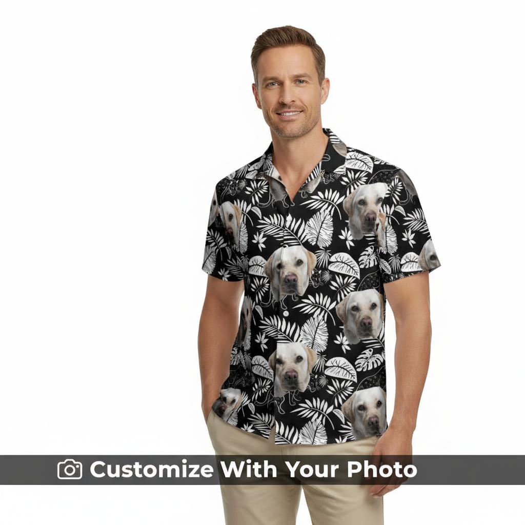 Men's black Hawaiian shirt with custom dog face and white tropical leaf pattern, styled at beachside café