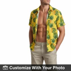 Yellow Hawaiian shirt with pineapple design worn by man by the ocean at golden hour