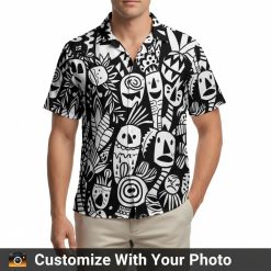 Black and white Hawaiian shirt with tribal face patterns on a man walking downtown