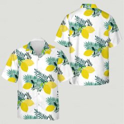 A Hawaiian shirt for women with yellow lemons and green leaves on a white background