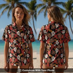 Woman wearing black, red, and white floral Hawaiian shirt with hibiscus print on beach