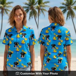 Woman smiles in blue dog face Hawaiian shirt with yellow rubber duck pattern outdoors