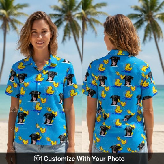 Woman smiles in blue dog face Hawaiian shirt with yellow rubber duck pattern outdoors