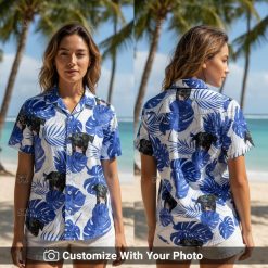 Woman wearing blue and white Hawaiian shirt with black dog face and tropical leaves