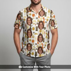 Hawaiian shirt with custom face print worn by man with tiki statues and drinks