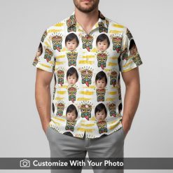 Hawaiian shirt with custom baby face print worn by man, colorful tribal design, beach at sunset