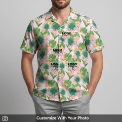 Man in personalized Hawaiian shirt with company logo and tropical leaf pattern