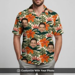 Man smiles in personalized Hawaiian shirt featuring face images, orange and green floral print.