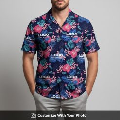 Man in custom Hawaiian shirt with company logo, navy blue and bright pink flowers
