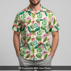 Man wearing custom Hawaiian shirt with logo, bold red flowers and leaf design
