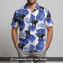 Man in blue and white Hawaiian shirt with black dog face and blue monstera leaves