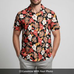 Man wearing tropical print Hawaiian shirt in black, red and white with hibiscus flowers