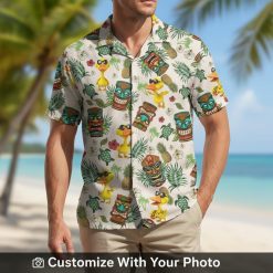 funny hawaiian shirt with tropical leaves and tiki masks worn by man on beach