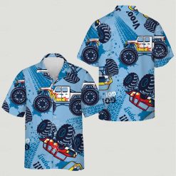 Large monster trucks with detailed wheels tire tracks text across blue shirt