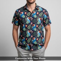 Man wearing navy Hawaiian shirt, toucan and leaf design, outdoor picnic table
