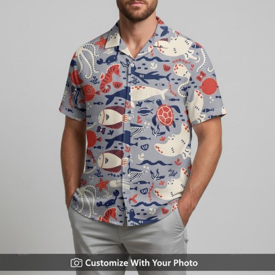 Man in ocean Hawaiian shirt featuring blue sea turtles, red fish, coral, and starfish