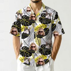 Matching cat and women's Hawaiian shirts with black, white, and yellow tropical leaves and faces