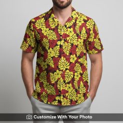 Man in vibrant floral Hawaiian shirt with yellow and red monstera leaf design
