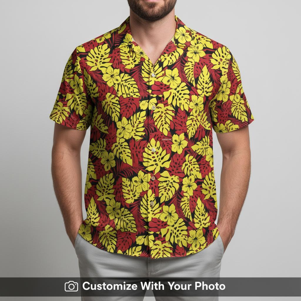 Man in vibrant floral Hawaiian shirt with yellow and red monstera leaf design