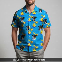Man wears blue Hawaiian shirt with black dog face and yellow rubber ducks print