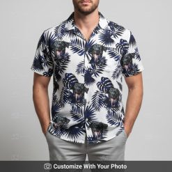 Man in black Hawaiian shirt with black dog face print and dark blue tropical leaves