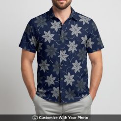 Man in black Hawaiian shirt with bold pink flowers and navy leaf pattern at the beach
