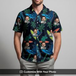 Man models black Hawaiian shirt with vibrant surfing dinosaurs and palm trees print