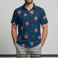 Man in bold blue Hawaiian shirt with pink flower and green leaf tropical print