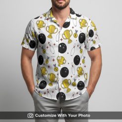 Man modeling a bright bowling Hawaiian shirt with pins, balls, trophies, and red accents design