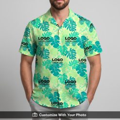 Man in custom logo Hawaiian shirt with turquoise and green monstera leaf print outside