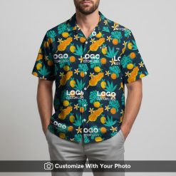 Man in custom logo Hawaiian shirt with bold orange fish and dark blue tropical pattern