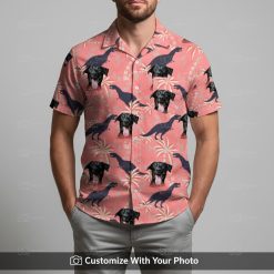 Man in pink dinosaur aloha shirt with black dog face and tropical palm tree print