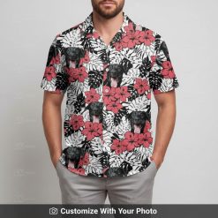 Man in red Hawaiian shirt featuring black dog face and vibrant yellow flowers