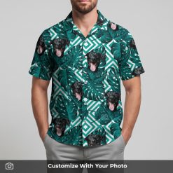 Man in white Hawaiian shirt with black dog, teal leaves, and geometric striped patterns