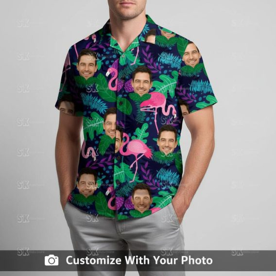 Man in men’s flamingo Hawaiian shirt with dark blue, pink, and green tropical leaves
