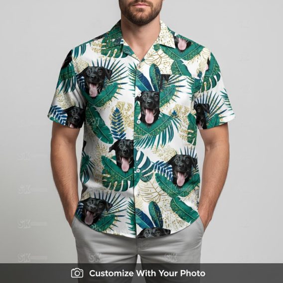Man in green and white Hawaiian shirt with dog picture and tropical leaf details