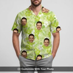 Man in custom green tropical face Hawaiian shirt with white hibiscus and palm leaves