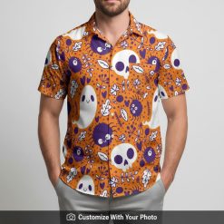 Man in Halloween button-up shirt with skulls, ghosts and colorful leaf details