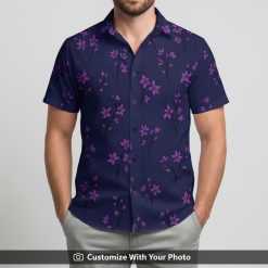 Man wearing a Hawaiian floral shirt with pink flower clusters on navy blue base