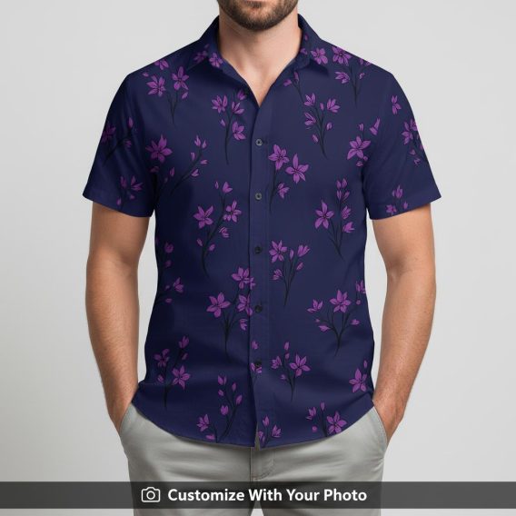 Man wearing a Hawaiian floral shirt with pink flower clusters on navy blue base