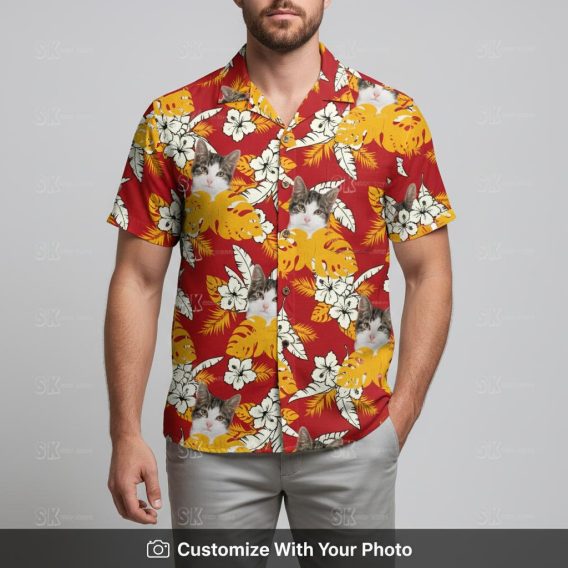 Man wearing Hawaiian shirt with cat face, red and yellow tropical leaves pattern